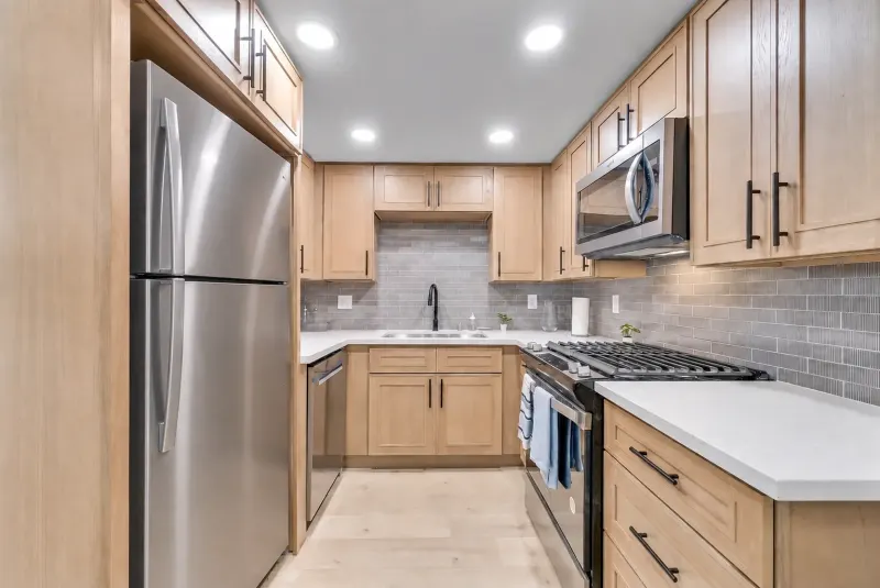 Kitchen with stainless refrigerator